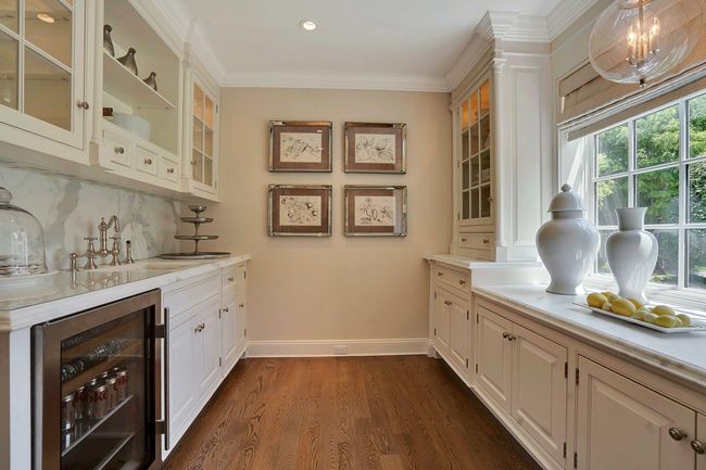 Butler's pantry room includes marble countertops and SubZero beverage and ice maker | Image 13