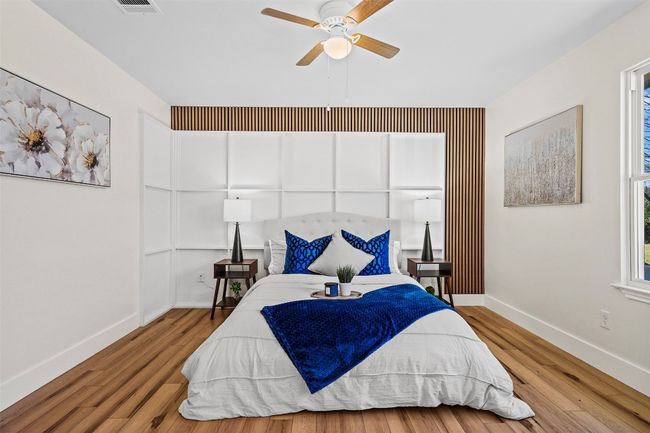 Bedroom with baseboards, wood finished floors, and ceiling fan | Image 21