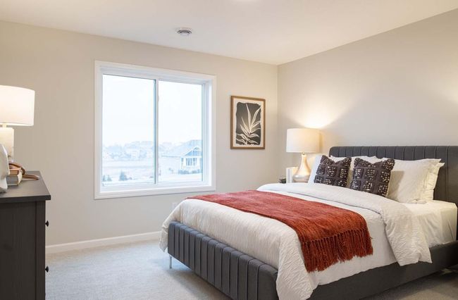 The lower level bedroom offers a private, comfortable retreat, perfect for guests or family members. Photos are from previously built home; features and options will vary. | Image 27