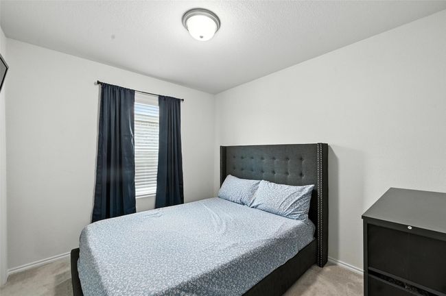 Bedroom featuring light carpet | Image 36