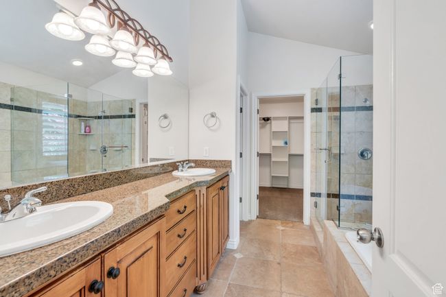 Full bath with a shower stall, double vanity, a spacious closet, and tile patterned floors | Image 22