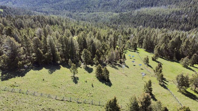 Aerial view of sparsely populated area with a heavily wooded area | Image 64