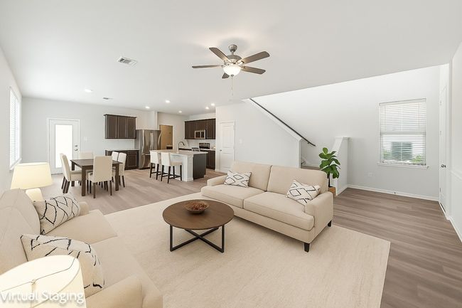 Living room with light wood-type flooring, healthy amount of natural light, a ceiling fan, baseboards, and recessed lighting | Image 4
