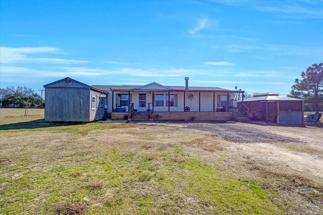 View of front facade featuring covered porch and a front yard | Image 25
