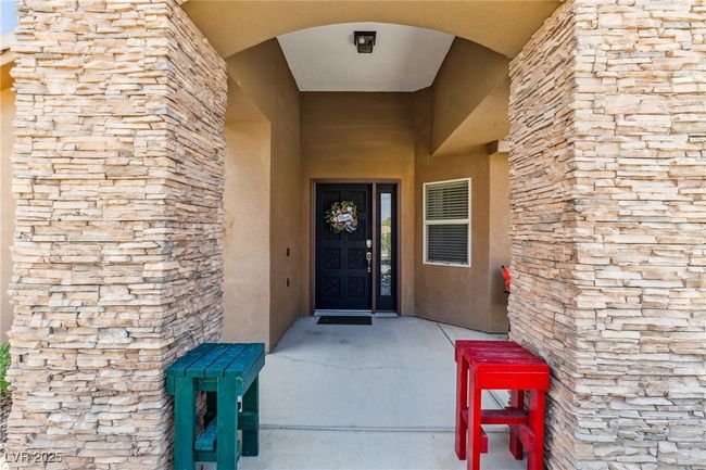 Doorway to property featuring stucco siding and stone siding | Image 5