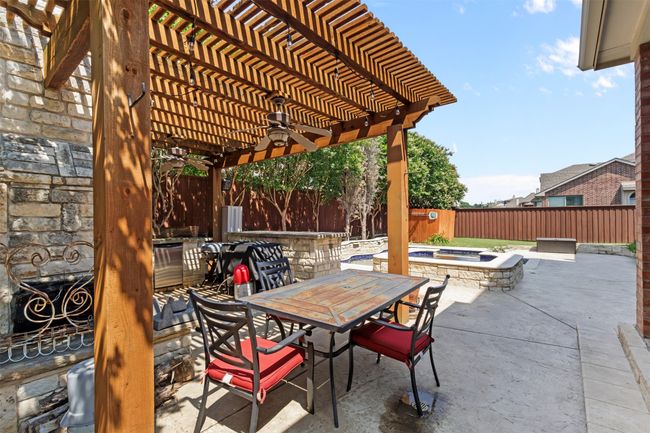 Fenced backyard with outdoor dining area, a ceiling fan, a patio, and a pergola | Image 38