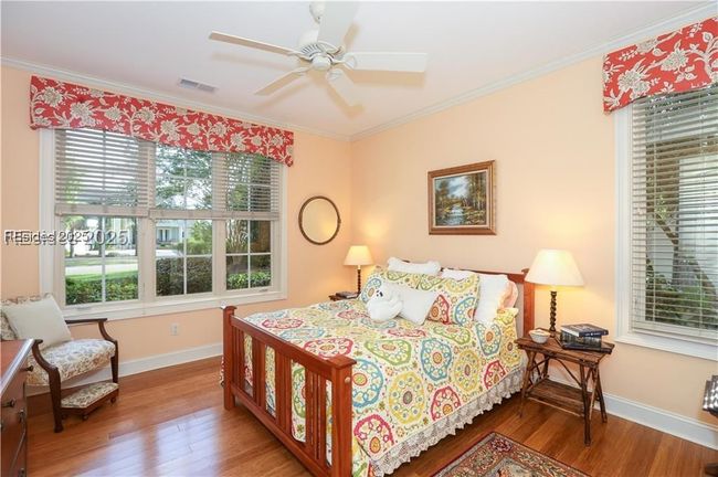 Bedroom 2 in the front of the home has an en-suite full bathroom for your guests. A Queen size bed is shown. | Image 38