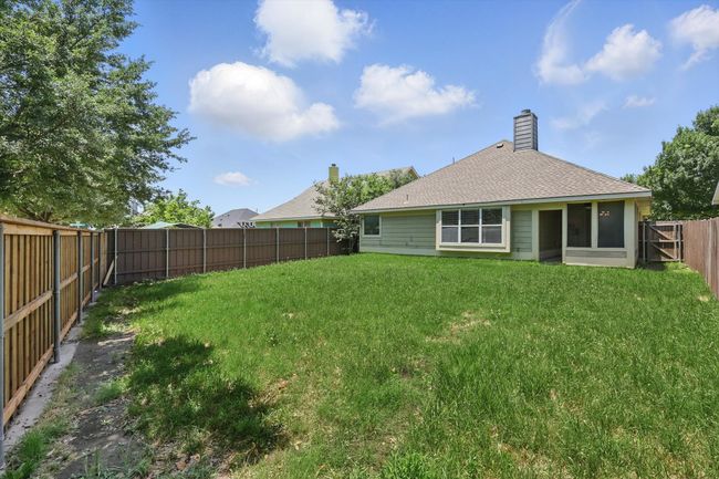 Back of property with a fenced backyard and roof with shingles | Image 26