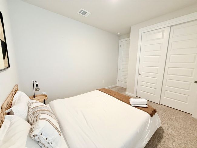 Bedroom featuring light carpet, a closet, and visible vents | Image 30