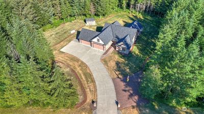 Aerial view of the home and tree lined property offering ample seclusion and privacy. | Image 2