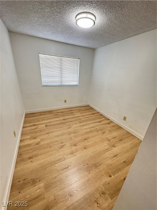 Empty room with wood finished floors and a textured ceiling | Image 34
