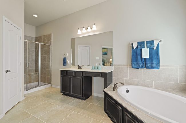 This well-appointed bathroom offers a serene setting for invigorating mornings or relaxing evenings, with ample space for personal care and comfort. | Image 23