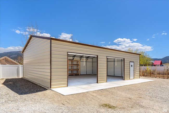 Detached garage featuring fence | Image 65