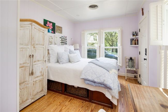 Bedroom with light wood-style floors and ornamental molding | Image 37