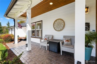 Cozy front porch with auto waterers awaiting your hanging baskets in the spring | Image 3