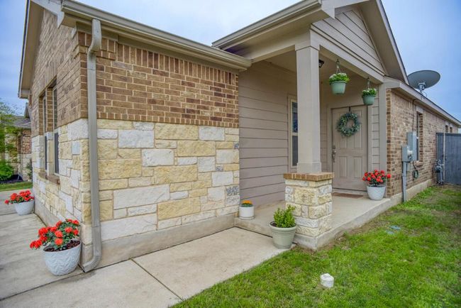 View of exterior entry featuring brick siding | Image 5