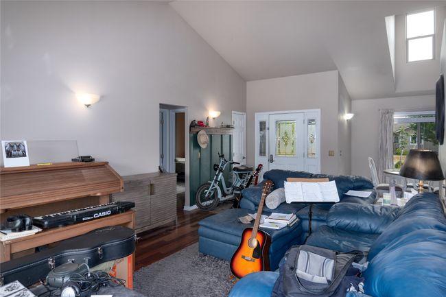 Living area featuring high vaulted ceiling and wood finished floors | Image 38