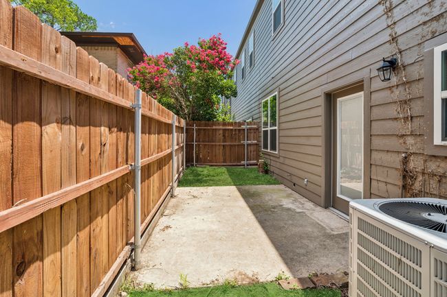 Fenced backyard with a patio area | Image 25