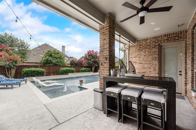 Fenced backyard with a patio and ceiling fan | Image 30