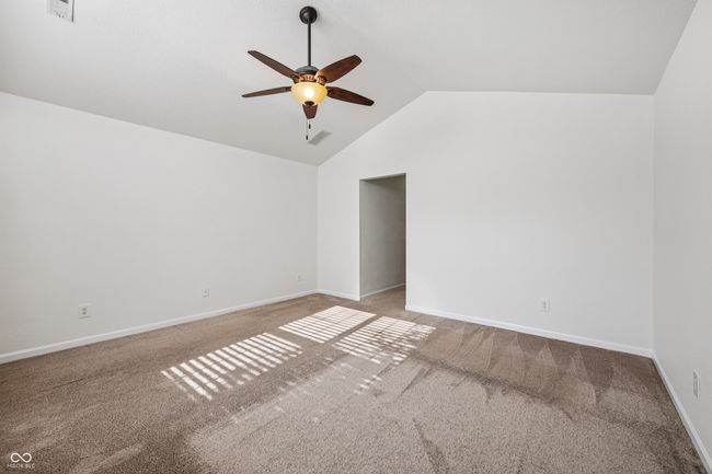 spare room with a ceiling fan, carpet, and lofted ceiling | Image 28
