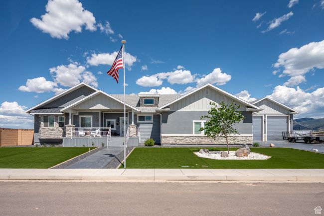Craftsman house featuring stone siding, covered porch, and a front lawn | Image 5