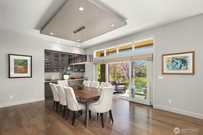 This generous dining area of the great room is perfect for both formal and informal dining. The built in bar and doors to the front patio make entertaining a breeze! | Image 8