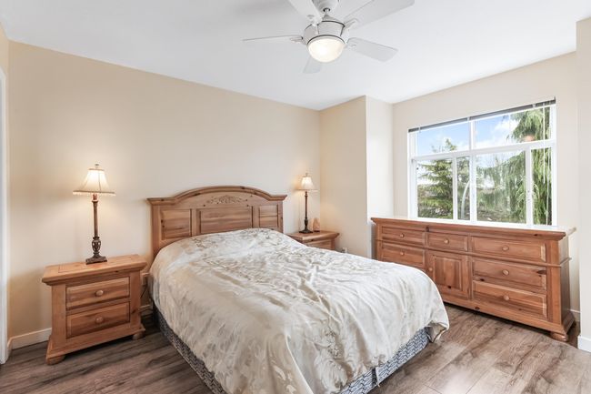 Bedroom with ceiling fan and wood finished floors | Image 18