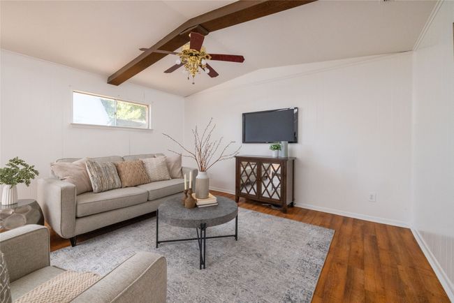 Living area featuring wood finished floors, ceiling fan, and baseboards | Image 6