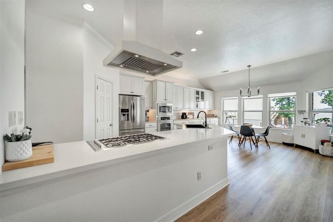 Kitchen and breakfast area featuring stunning panoramic views of the lake | Image 14