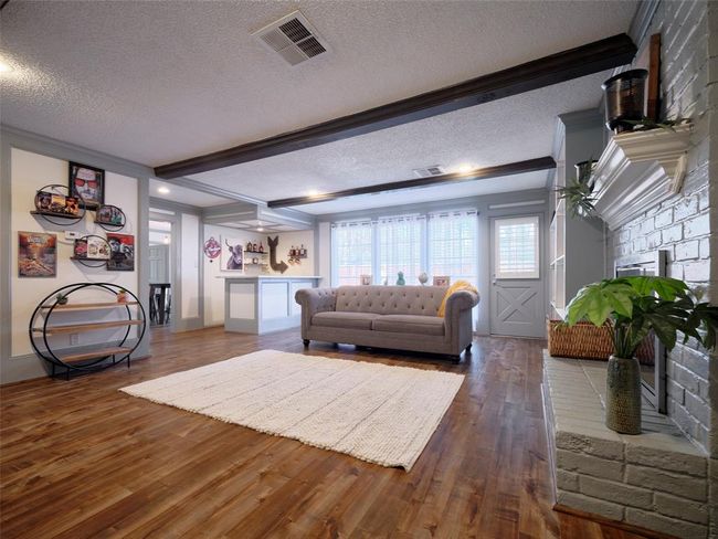With engineered flooring and an upgraded wet bar, this room is perfect for entertaining or enjoying quiet evenings with family. | Image 6