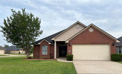 View of front of house with a garage and a front lawn | Image 1