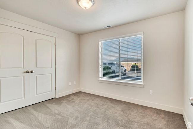Unfurnished bedroom featuring light colored carpet and a closet | Image 18
