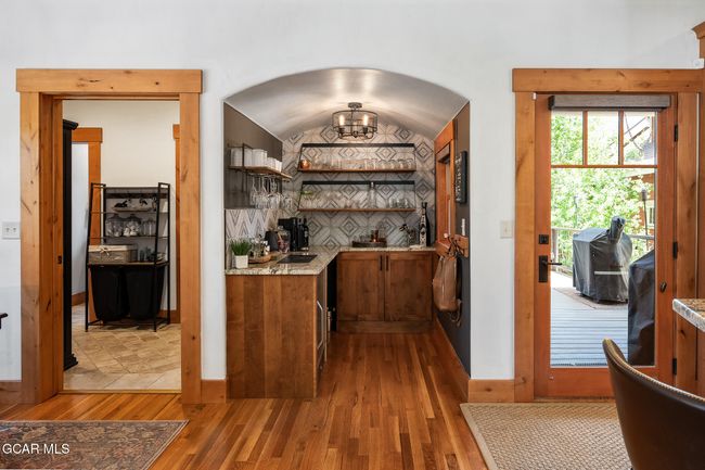 Bar area with wine fridge and extra storage | Image 9