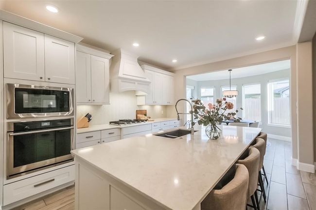 The large quartz island is perfect for entertaining with plenty of room to bake cookies with the kids or host large gatherings. | Image 12