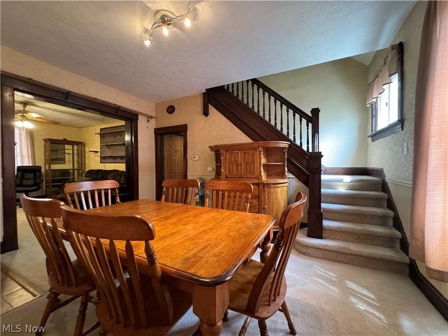 Dining space featuring a textured ceiling, ceiling fan, and rail lighting | Image 4