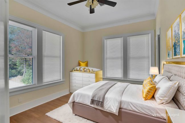 Bedroom with ornamental molding, wood finished floors, and a ceiling fan | Image 21