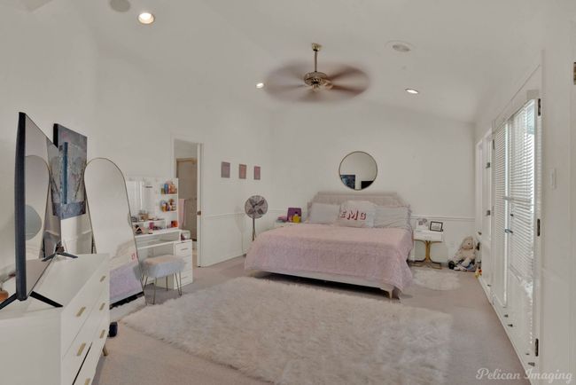 Carpeted bedroom with a ceiling fan, lofted ceiling, and recessed lighting | Image 20