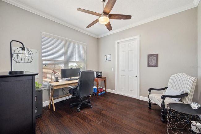 This bedroom/office is located on the 2nd floor. The door in back leads to the front balcony. | Image 56