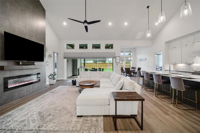 Soaring 12’ ceilings and a wall of windows fill the great room with natural light. | Image 10