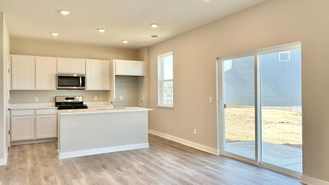 Photo of actual home! Spacious and open main floor. Concrete patio off 6ft sliding door. Perfect for entertaining. | Image 5