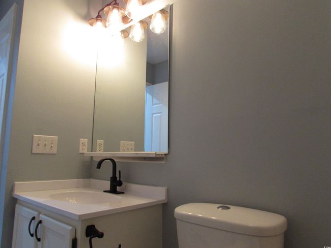Full bathroom featuring a vanity and light fixture. | Image 18