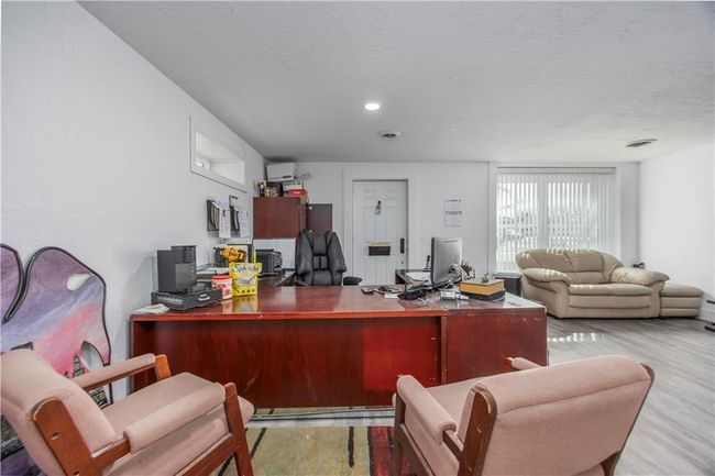 Home office with wood finished floors and a textured ceiling | Image 16