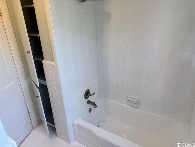 Bathroom featuring tile patterned flooring and tiled shower / bath combo | Image 31