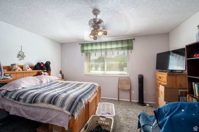 Carpeted bedroom featuring a textured ceiling | Image 14