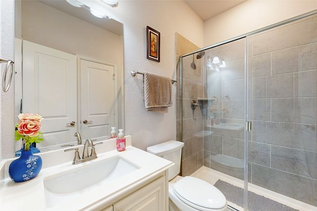 Full bath featuring toilet, vanity, and a shower stall | Image 34
