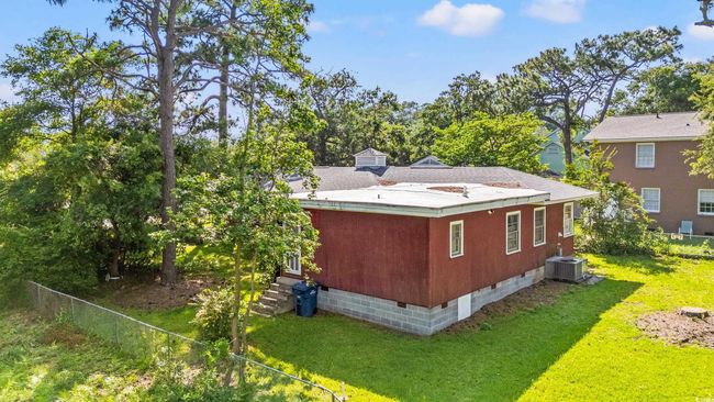 View of side of property featuring crawl space and a central AC unit | Image 26