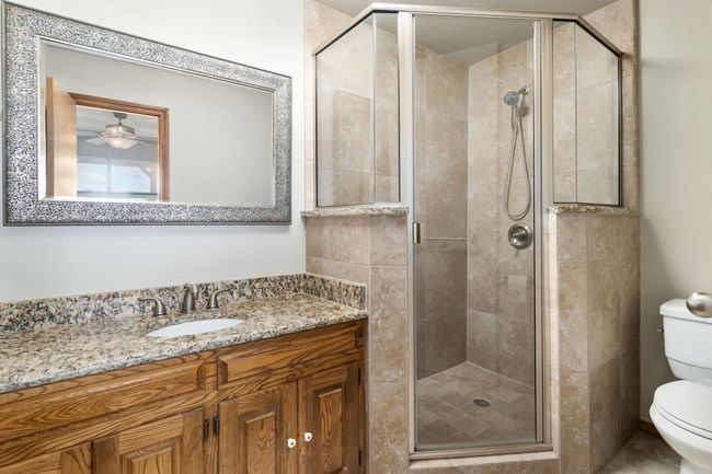 Full bath with ceiling fan, vanity, toilet, and a stall shower | Image 32