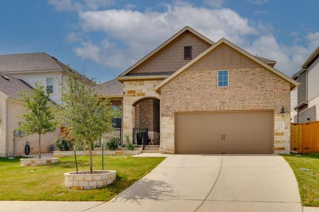 View of front of home featuring brick siding, driveway, stone siding, board and batten siding, and a shingled roof | Image 5