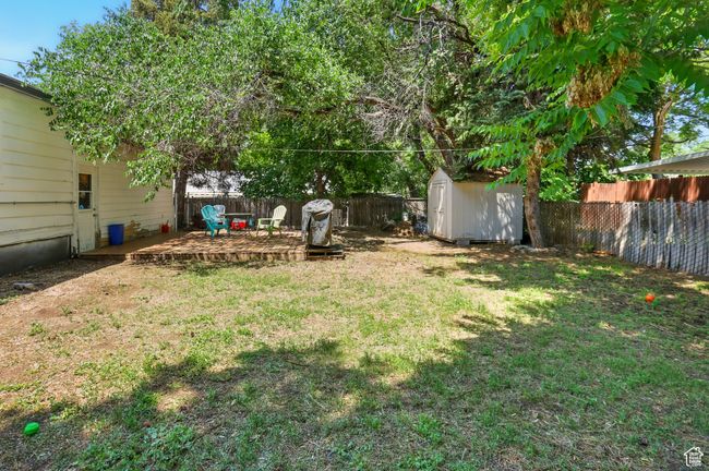 Fenced backyard featuring a shed | Image 27