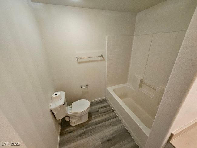 Full bathroom featuring wood finished floors and toilet | Image 27